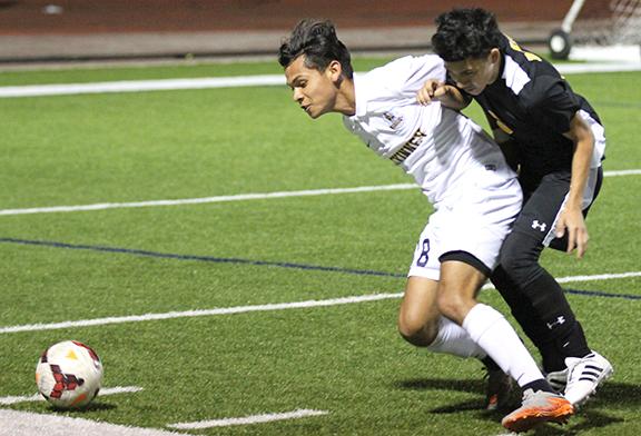 At the Denison game junior Pedro Sanchez defends the ball. The lions won 4-0.