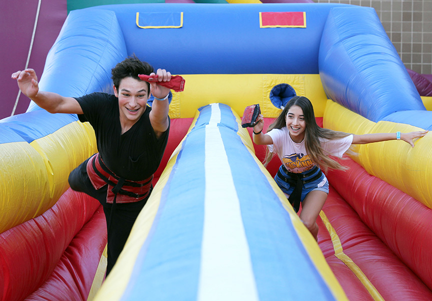 Two students compete at the bungee race at the Homecoming Carnival.