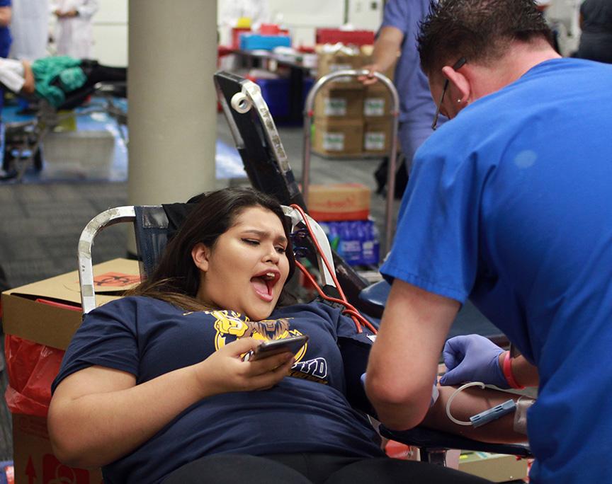 At the school blood drive, senior Angela Hernandez dramatically reacts to getting her blood drawn.