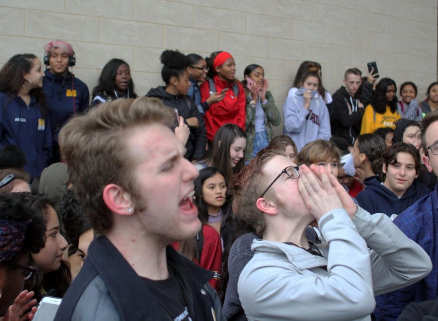 In order to raise awareness for the protest,  seniors Christian Rushing and Jack Miles begin a chant demanding for change.