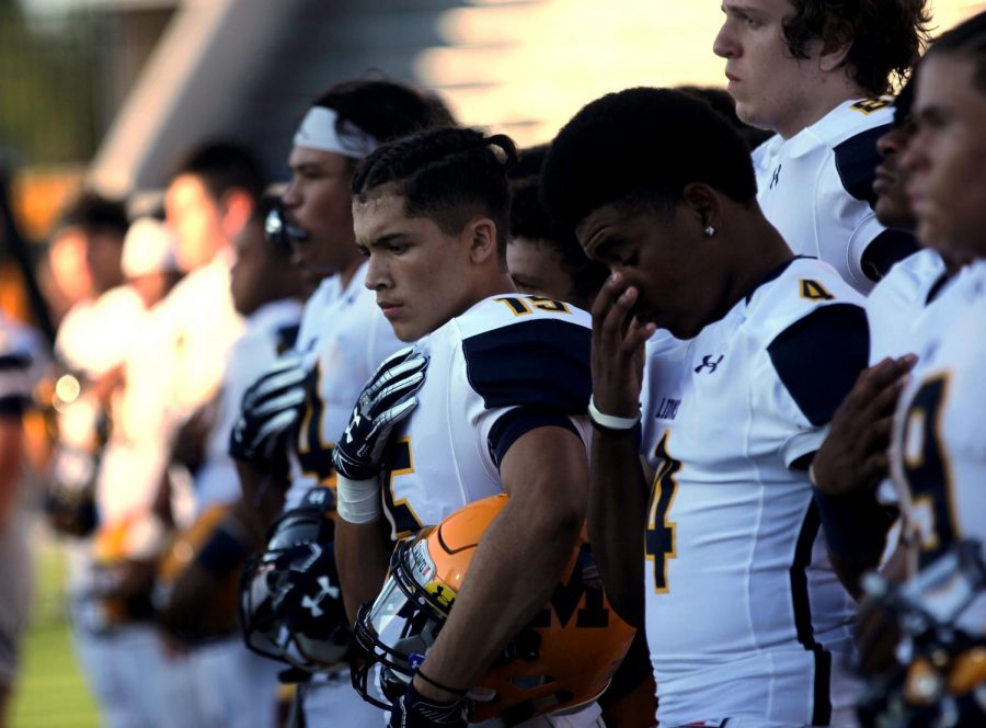 Isaiah Rojas stands in line with his teammates during the pledge of allegiance.
