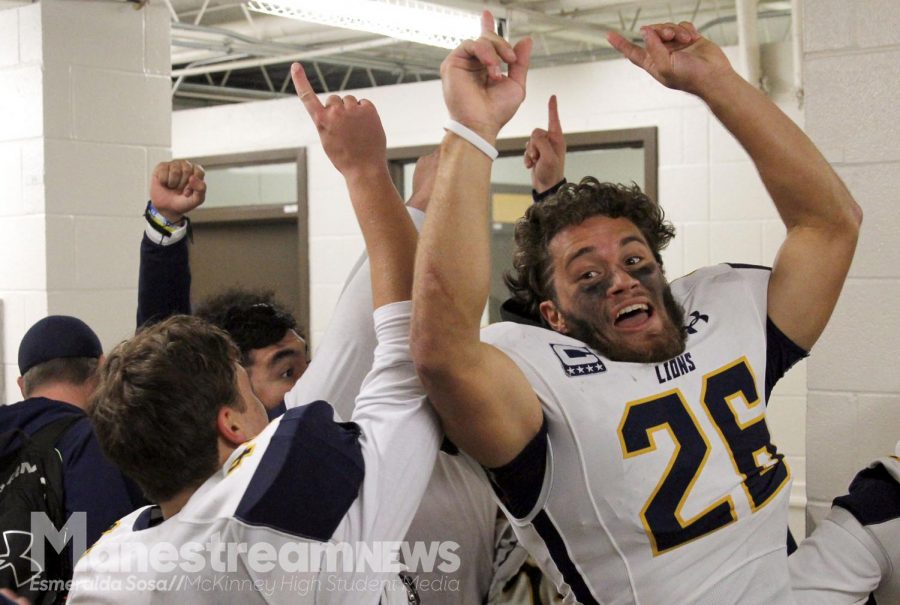 After the game, junior Jack Moses celebrates the win the in locker room.