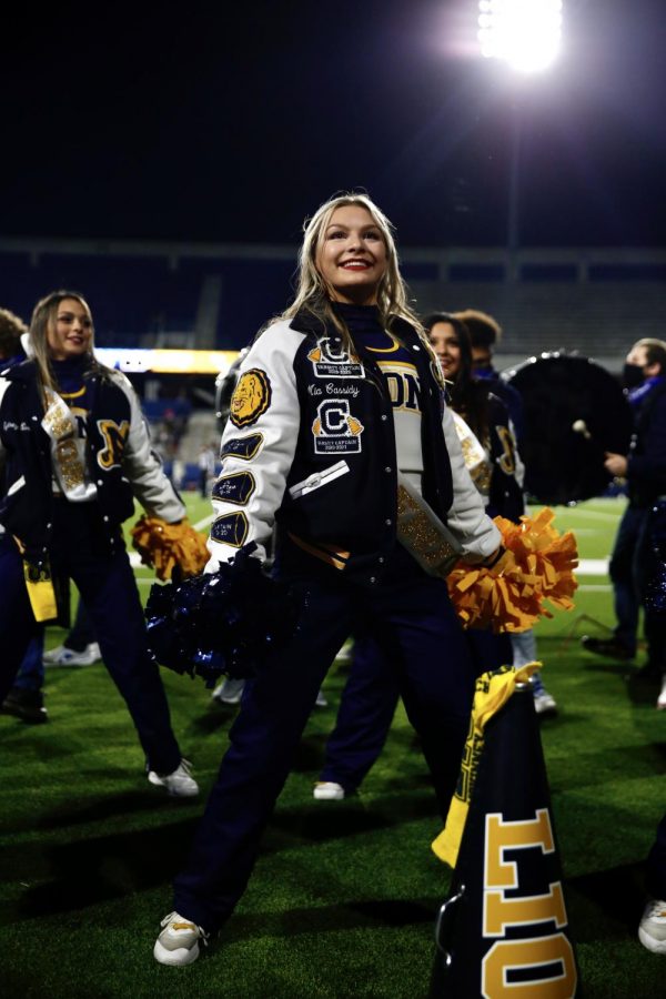Senior Mia Cassidy cheers on the sidelines of the last football game of the year vs. Little Elm. 